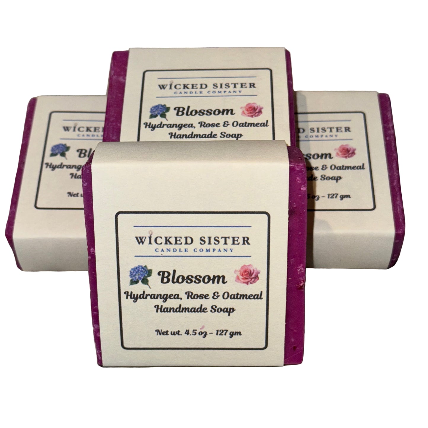 Four bars of Wicked Sister Candle Company soap on a white surface