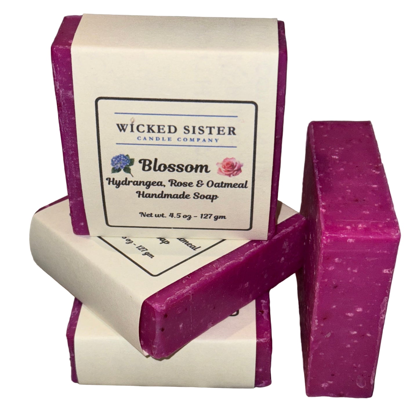 Blossom rose, oatmeal soap bars with a 'Wicked Sister Candle Company' label on a white surface.