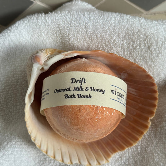 Oat milk bath bomb in a shell with a label on a towel