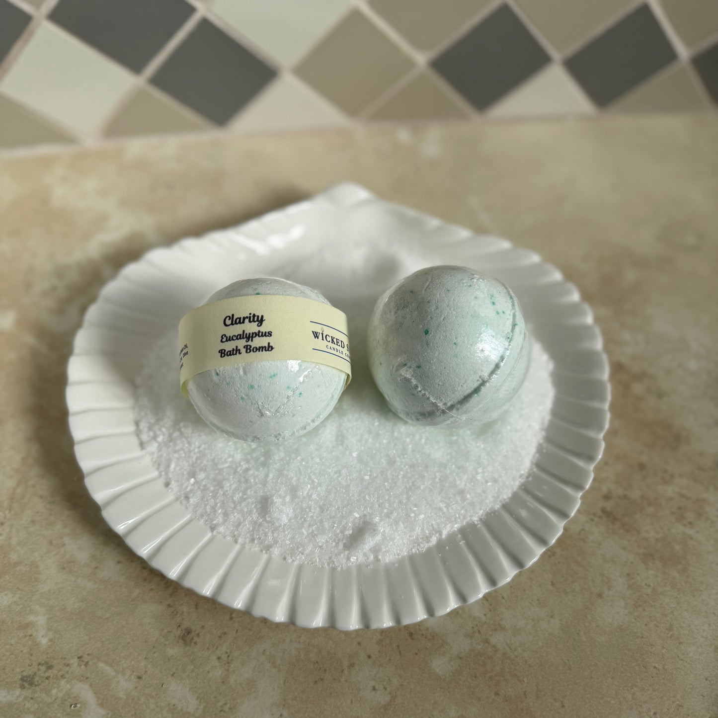 Two bath bombs in a seashell full of bath salt