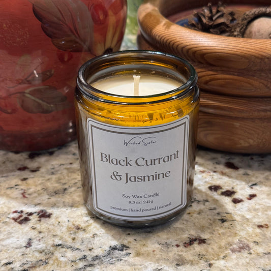 Jasmine candle with a label on a granite surface