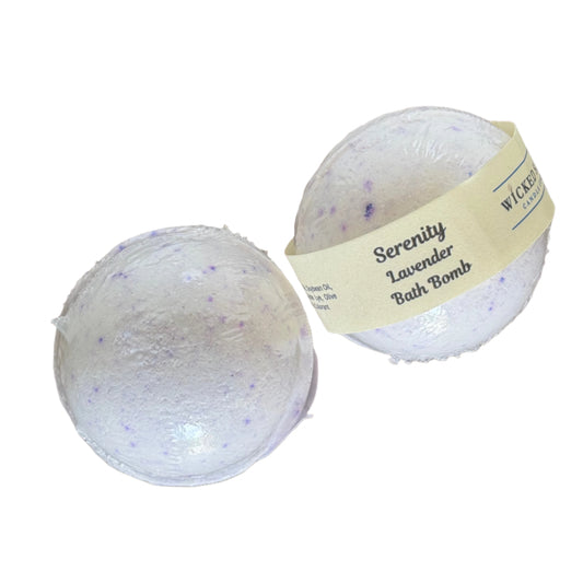 Two lavender bath bombs on a white surface, one with a label.