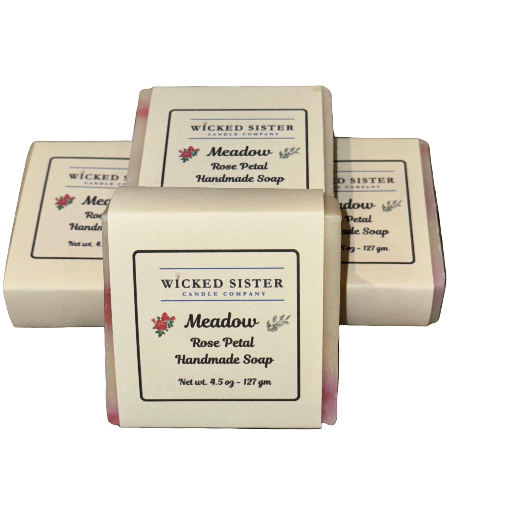 Handmade soap bars with 'Wicked Sister Candle Company' packaging on a white surface