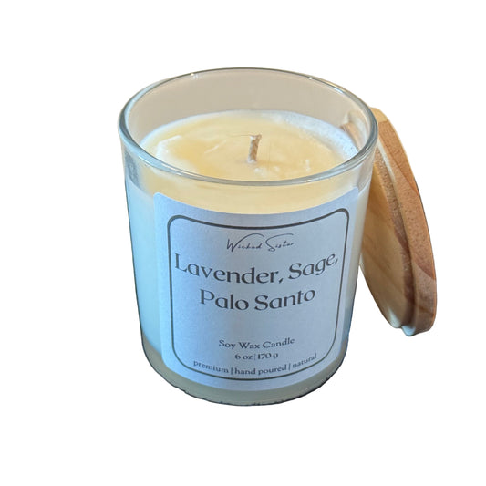Wicked Sister candle in a glass jar with a wooden lid on a white background