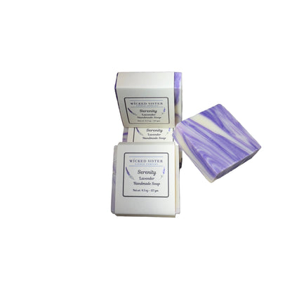 Two bars of lavender soap with packaging on a white countertop